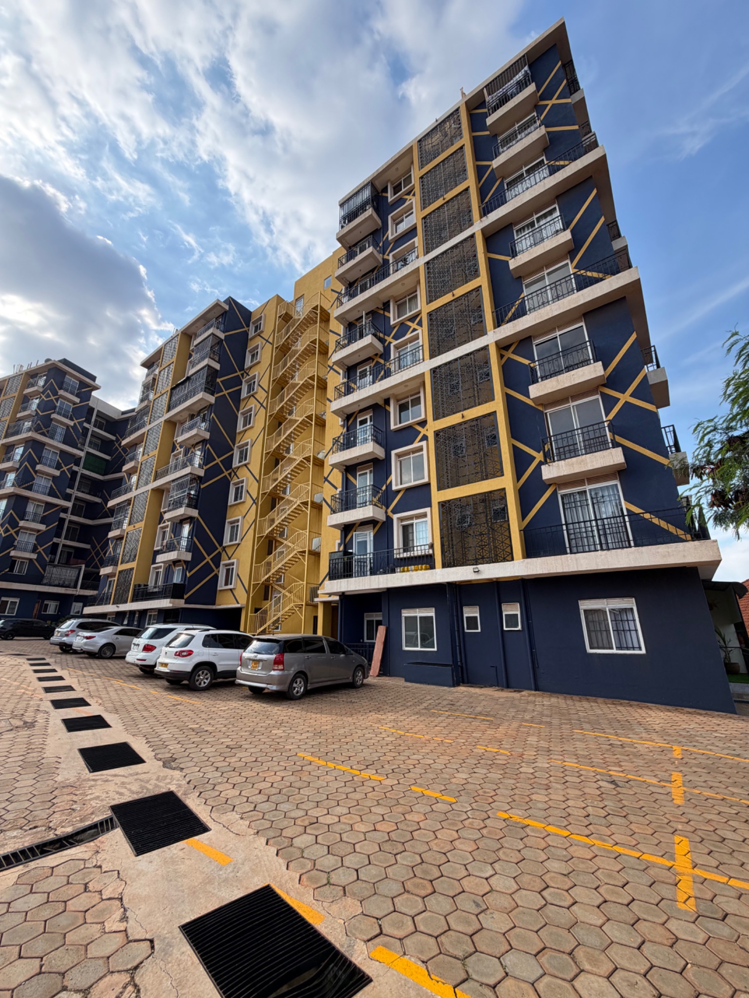 Real photograph of Falcon and Robin apartment buildings and parking courtyard